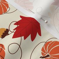 Pumpkins and acorns on cream background 