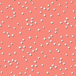 Tossed white swiss dots on coral pink, 1/4 inch dots