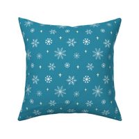 White snowflakes and pale yellow stars against a glacier blue background