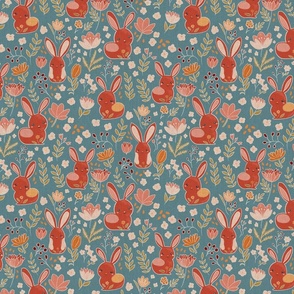 Faux linen easter bunnies in terracotta red and orange on a teal blue background
