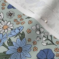 Sketched raw wildflowers spring fields - freehand drawn flower design blue periwinkle on mist green