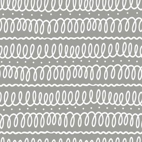 White squiggles on grey, hand drawn white doodle loops on grey