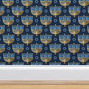 Golden hanukkah menorah with candles on textured deep blue | medium