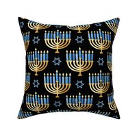 Golden hanukkah menorah with candles on black | medium