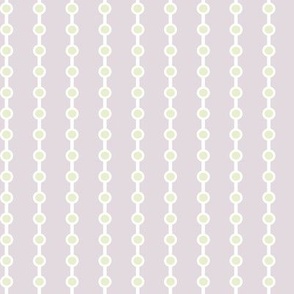 Yellow Beads White Strands Lavender Background