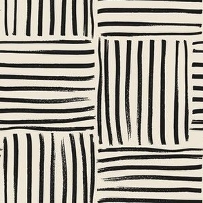 Large scale hand drawn geometric weave stripe block in black and beige.