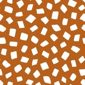 Tossed white square spots on dark orange background - freehand marker strokes