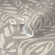 Cream ornament on beige background with herringbone fabric texture.