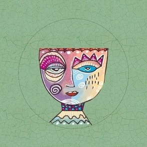 Surrealist whimsical doodled face in pastels embroidery hoop in 8” swatch for 6” embroidery hoop on sage green crackle background 6