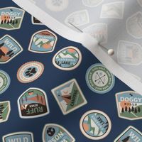 Dog adventures - tossed vintage springtime camping stickers and mountain badges with wet noses muddy paws and summer camp nature patches blue green orange on navy blue SMALL