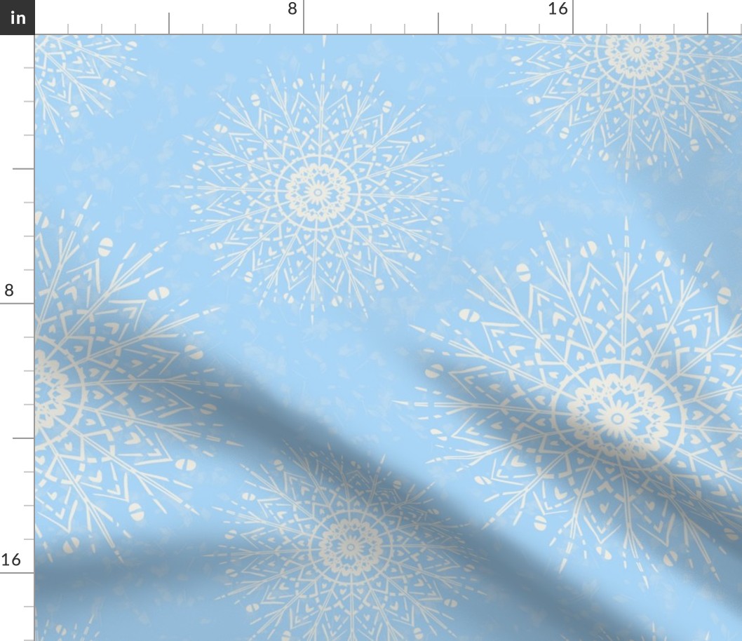 White Mandalas and snow on a light blue background - large scale