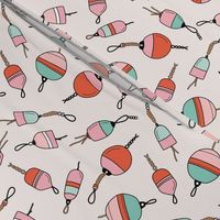 Out on the boat - fishing boat buoys freehand tossed retro marine design coral pink on sand