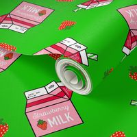 Strawberry Milk Carton With Straw & Strawberries On A Green Background 
