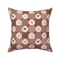 Strawberry patchwork with stitches on a textured plaster background in cream and earth tones.