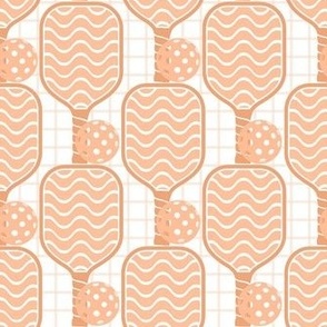 Medium Scale Pickleball Paddles and Balls in Peach Fuzz Pantone Color of The Year 2024