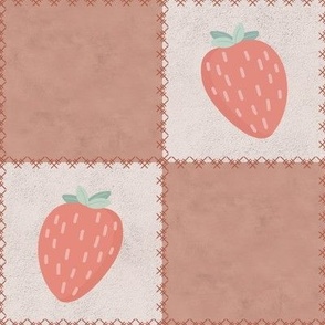Strawberry patchwork with stitches on a textured plaster background in cream and warm pink apricot color