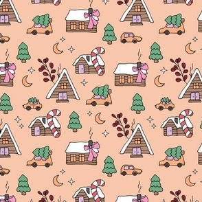 Cutesy little christmas village with retro bows candy christmas pine trees cabins cars moon and stars green pink on peach fuzz