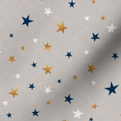 Gold, blue, and white stars on a light gray textured background. 
