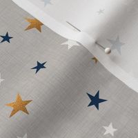 Gold, blue, and white stars on a light gray textured background. 