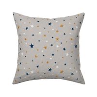 Gold, blue, and white stars on a light gray textured background. 