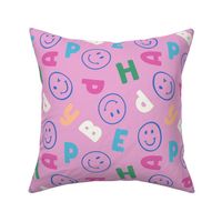 (M) Spread joy with this playful cobalt blue smile face with varsity letter/alphabetic character in hot pink, green, yellow on barbie pink background. Ideal for kids' clothes and bedroom.