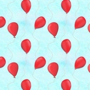 Vibrant Red Balloons Against a Blue Sky with White Clouds