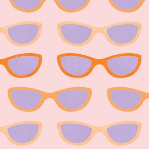 Orange and purple sunglasses on pink background