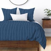 Wide - Chambray denim grungy, wavy, hand drawn stripes on an indigo blue, faux denim woven textured background. 