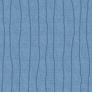 Wide - Indigo denim grungy, wavy, hand drawn stripes on a chambray blue, faux denim woven textured background. 