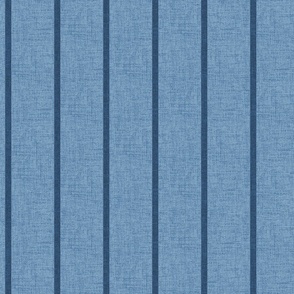 1/2" wide indigo denim pencil stripes on a chambray blue,  faux denim woven textured background. 
