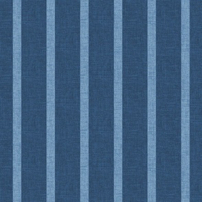 1" wide chambray denim pencil stripes on an indigo blue, faux denim woven textured background. 