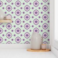 Geometric block print blooms in mint green & purple featuring circles of poppy seeds florets for nature-inspired living decor, wallpaper & bedding