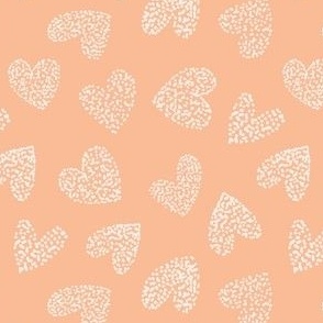 Hand drawn hearts and dots in peach fuzz and light creme