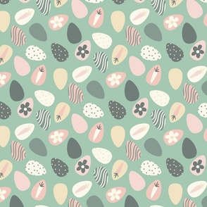 easter eggs neutrals on green background