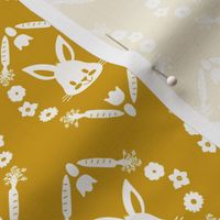 small easter bunnies in floral ovals in eggshell on gold