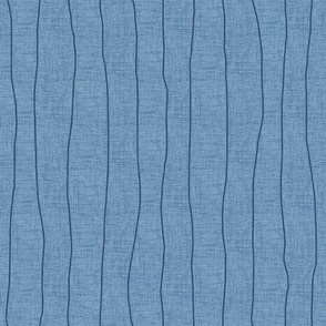 Medium - Indigo denim grungy, wavy, hand drawn stripes on a chambray blue, faux denim woven textured background. 