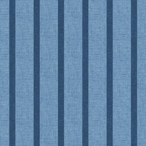 1/2" wide indigo denim pencil stripes on a chambray blue, faux denim woven textured background. 