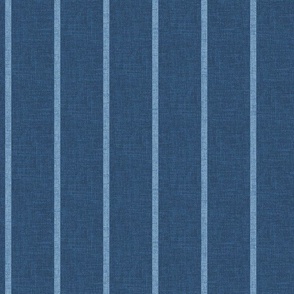 1/4" wide chambray denim pencil stripes on an indigo blue, faux denim woven textured background. 