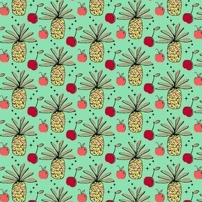 Pineapple, apple, cherry on green background