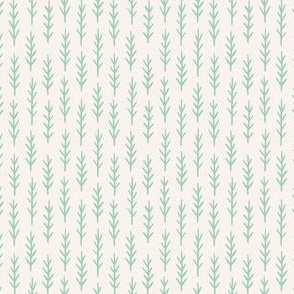 Light green twigs on white, tiny pine tree forest
