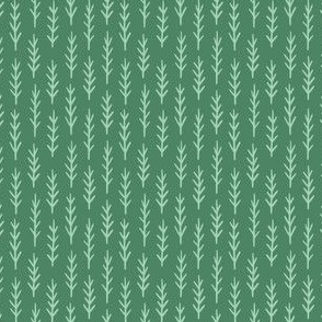 Light mint green twigs on dark green, tiny pine tree