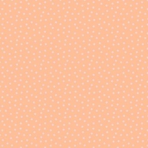 Peach fuzz with freely placed polka dots