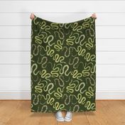 Large Green and Gold Leaf Snakes on Forest Green