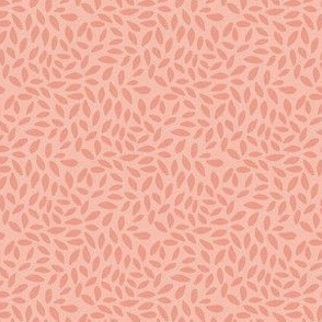Delicate pink leaves densely packed on a coral pink background creating a textural effect