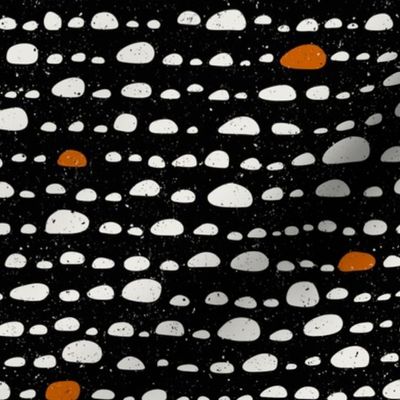(M) Black and orange-brown  stones on off-white