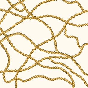 Kitschy gold pearl chain on cream backdrop (large)