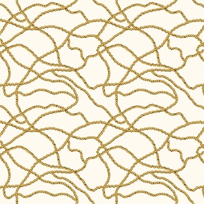 Kitschy gold pearl chain on cream backdrop  (medium)