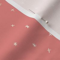 Small scale folk art style stars in the night sky in coral red