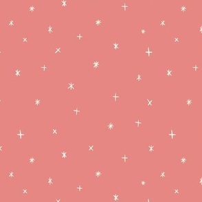 Small scale folk art style stars in the night sky in coral red