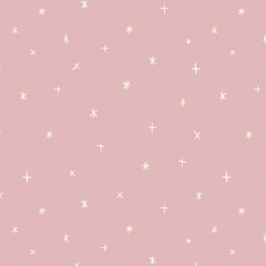 Small scale folk art style stars in the night sky in dusty pink